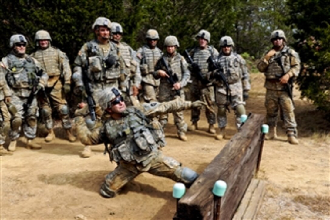 An Army soldier launches a dummy grenade from the kneeling position at Camp Swift in Bastrop, Texas, on Aug. 13, 2011.  The soldier is assigned to Task Force Raptor, which refines basic soldier skills as part of its premobilization training.  