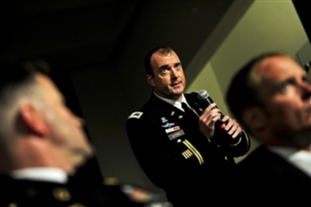 An audience member asks a question during a televised conversation on defense issues between Defense Secretary Leon E. Panetta and Secretary of State Hillary Rodham Clinton at National Defense University in Washington, D.C., Aug. 16, 2011. Frank Sesno, director of the School of Media and Public Affairs at George Washington University, moderated the event.