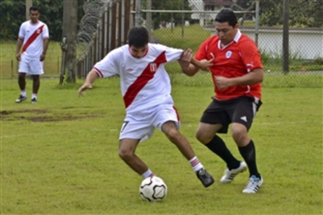 A sailor attached to a Chilean ship tries to take the ball from a Peruvian sailor at a soccer match during Panamax 2011 at the Vasco Nunez de Balboa Naval Base in Panama City, Aug. 15, 2011. U.S. Southern Command sponsors the annual, multinational training exercise to focus on the security of the Panama Canal. The 12-day exercise, which includes more than 3,500 civil and military personnel from 17 nations, takes place off the coasts of Panama and the United States.