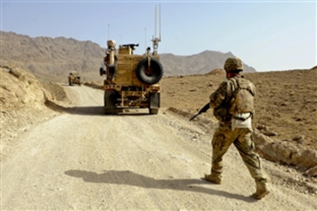 U.S. Army Staff Sgt. Michael Lovett moves to his mine-resistant, ambush-protected vehicle during a humanitarian aid visit in Arghandab, Afghanistan, Aug. 15, 2011. Lovett is a member of the security force for Provincial Reconstruction Team Zabul, which conducts civil-military operations in the province to extend the reach and legitimacy of the Afghan government.