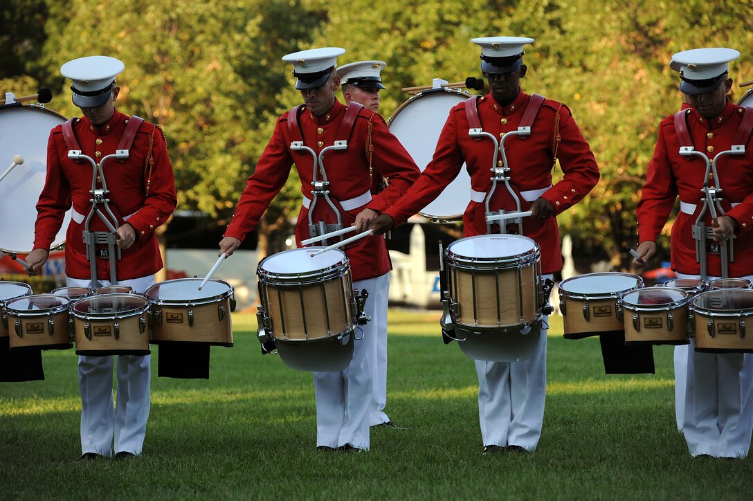 The percussion section of the U.S. Marine Drum and Bugle Corps performs in a Tuesday Sunset Parade at the Marine Corps War Memorial in Arlington, Va., Aug. 16, 2011. The D&B executes their unique musical routine in every parade at Marine Barracks Washington and the war memorial.