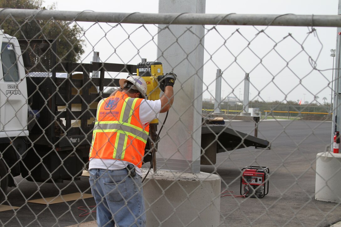 A construction worker builds onto a support beam for a new parking area aboard Marine Corps Recruit Depot San Diego Aug. 16. This is no ordinary parking area, the roof will be lined with solar hot water heating panels. This is just one part of an energy saving project that will help MCRD go green.