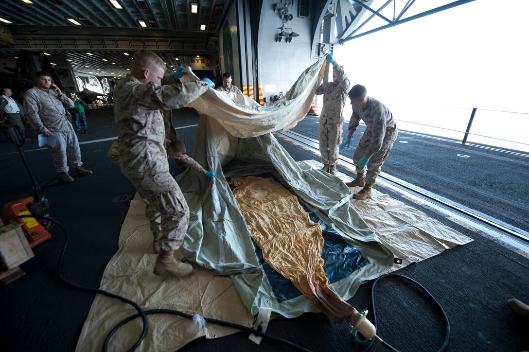 Marines serving with the 11th Marine Expeditionary Unit's command element aboard the amphibious assault ship Makin Island prepare to launch a communications balloon Aug. 16. The balloon is designed to carry a radio-relay system up to 80,000 feet above Earth, extending communications to an area 600 miles in diameter, regardless of terrain. The launch from sea signaled the unit's and the ship's first of a device of its kind.