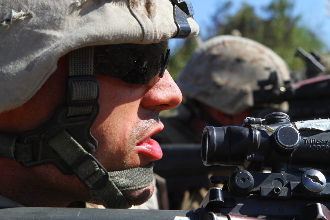 Team leader Cpl. Adam Patton looks beyond his sights here Aug. 16 during a live-fire exercise with Company L, one of three rifle companies in Battalion Landing Team 3/1, the ground combat element for the 11th Marine Expeditionary Unit. Company L spent five days in the field during the unit’s first sea-based training since becoming a complete Marine air ground task force in May. The company disembarked USS New Orleans off Pendleton’s coast and was driven ashore by amphibious assault vehicles. A platoon of tracked vehicles from 3rd Assault Amphibian Battalion, Camp Pendleton, reinforces the Pendleton-based 3rd Battalion, 1st Marines. The platoon provides the go-to means of maneuver for Company L. Patton is a 24-year-old Reno, Nev., native.