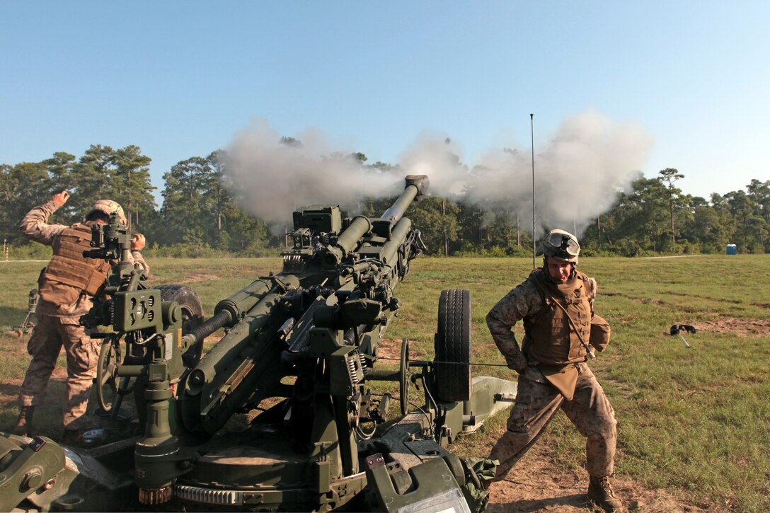 Marines with Alpha Battery, 1st Battalion, 10th Marine Regiment, 2nd Marine Division, fired rounds down range at targets during training aboard Marine Corps Base Camp Lejeune, N.C., Aug. 15-17, 2011. When the Marines are given the order to fire, they pull the lanyard which shoots the round up to 25 miles away. (U.S. Marine Corps photograph by Pfc. Phillip R. Clark)