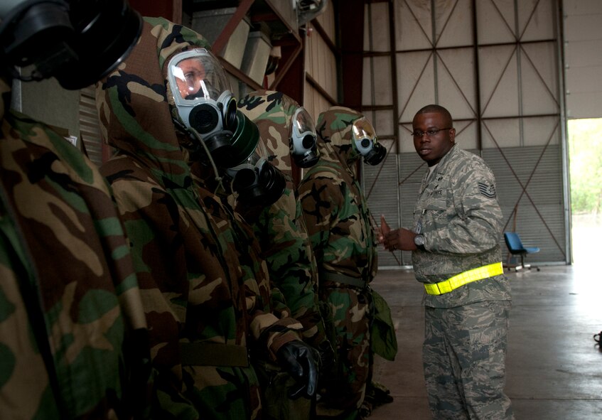 VOLK FIELD. Wis. -- Tech. Sgt. Jesse Burns, 319th Training Squadron cadre instructor from Lackland Air Force Base, Texas,, inspects 459th Air Refueling Airmen from Joint Base Andrews, Md., for proper wear of chemical warfare suits during an Operational Readiness Training Program here Aug. 17. The 459 ARW  gained additional skills and practiced techniques in the ORTP that prepared the Reserve Airmen for both real-world rapid deployment scenarios and an upcoming Operational Readiness Inspection in 2012. (U.S. Air Force Photo/Tech. Sgt. Steve Lewis) 
