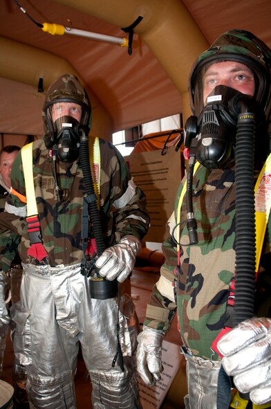 VOLK FIELD. Wis. -- Firefighters, Senior Airman Adrian Golodoinski (left) and Senior Joshua Prila, 459th Civil Engineering Squadron, Joint Base Andrews, Md., learn how to decontaminate fire protection and chemical warfare suits during an Operational Readiness Training Program here Aug. 17. The 459 ARW  gained additional skills and practiced techniques in the ORTP that prepared the Reserve Airmen for both real-world rapid deployment scenarios and an upcoming Operational Readiness Inspection in 2012. (U.S. Air Force Photo/Tech. Sgt. Steve Lewis) 