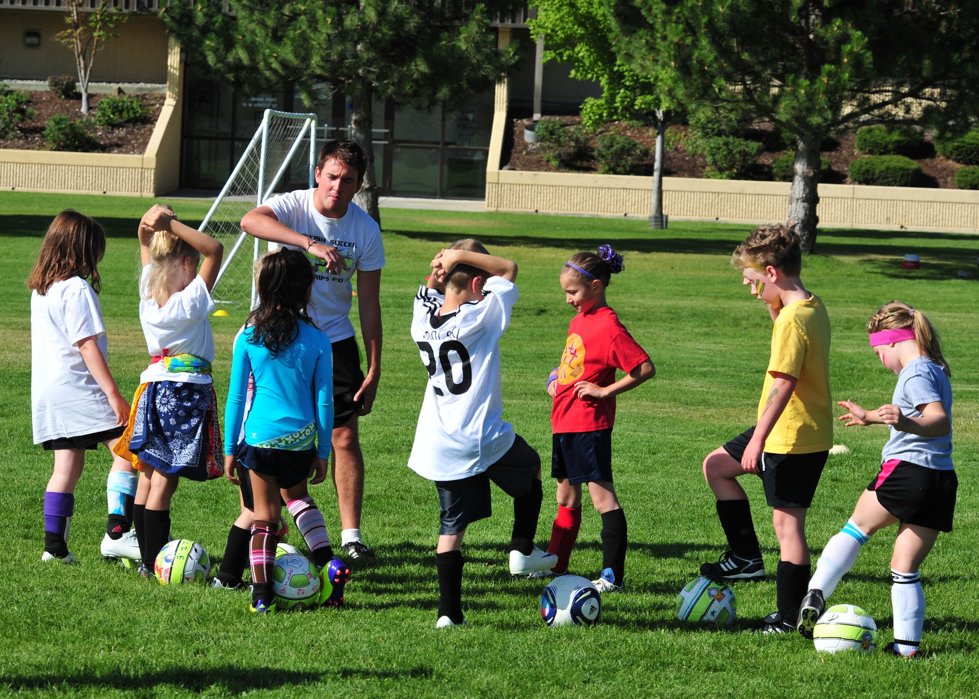 Anthony O’Brien, British soccer coach, runs practice drills with Fairchild youth Aug. 10. The Fairchild Youth Center partners with U.K.-based Challenger Sports to bring the British coaches to the base in an effort to broaden thier soccer and worldly knowledge. (U.S. Air Force photos/Staff Sgt. Michael Means)