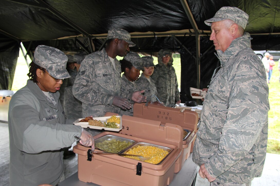 Senior Airman Cherie Randall serves hot lunch to 932nd Airlift Wing members  at a recent training assembly.  The 932nd Services Flight set-up tents, generators and fed more than 100 Reservists in about an hour.  The recurring field training is conducted to sharpen contigency skills . (U.S. Air Force photo/Tech. Sgt. Christopher Parr) 