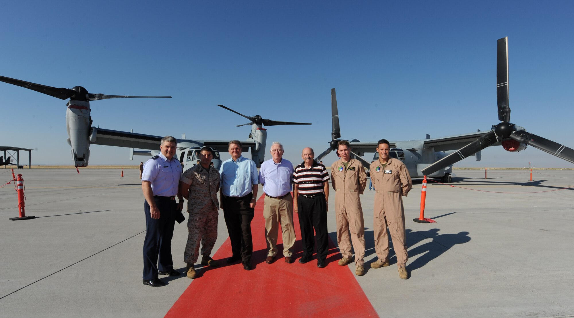 Col. Ron Buckley, 366th Fighter Wing commander, and members of Marine Medium Tiltrotor Squadron 166 out of Marine Corps Air Station Miramar, Calif., pose for a photograph with civic leaders in front of two VM-22 Osprey aircraft after a tour at Mountain Home Air Force Base, Idaho, Aug. 17, 2011. The MV-22 Osprey aircraft can transport 24 combat troops, 20,000 pounds of internal cargo or up to 15,000 pounds of external cargo using its medium lift and vertical takeoff and landing capabilities. (U.S. Air Force photo by Senior Airman Debbie Lockhart)