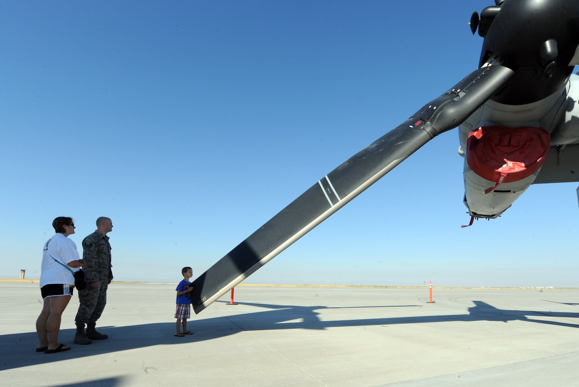 A young boy inspects a propeller of an MV-22 Osprey aircraft assigned to Marine Medium Tiltrotor Squadron 166 out of Marine Corps Air Station, Miramar Calif., at a static display on the flightline, at Mountain Home Air Force Base, Idaho, Aug. 17, 2011. The MV-22 Osprey aircraft is a tilt-rotor aircraft which takes off and lands like a helicopter. Once airborne, its engines can be rotated to convert the aircraft to a turboprop airplane capable of high-speed and high-altitude flight. (U.S. Air Force photo by Senior Airman Debbie Lockhart)