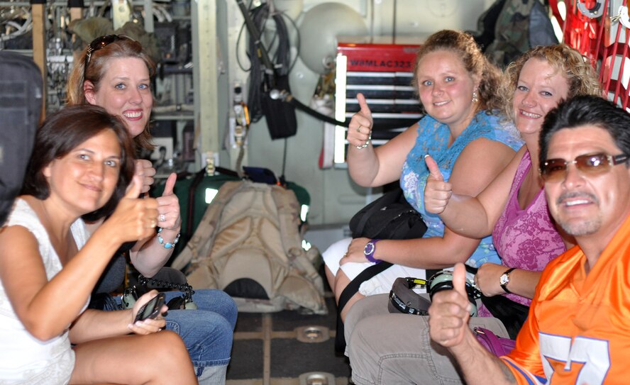 Spouses of 302nd Airlift Wing Airmen give a 'thumbs up' before taking off in a C-130 Hercules aircraft Aug. 7 during the Wing Spouse's Orientation Flight at Peterson Air Force Base, Colo. The spouses rode along on a local training mission which included flying over Pikes Peak, where they were able to see, firsthand, how the C-130 flight crew works together to accomplish a typical training mission. More than 60 spouses participated in the orientation flight. (U.S. Air Force photo/Staff Sgt. Stephen J. Collier)