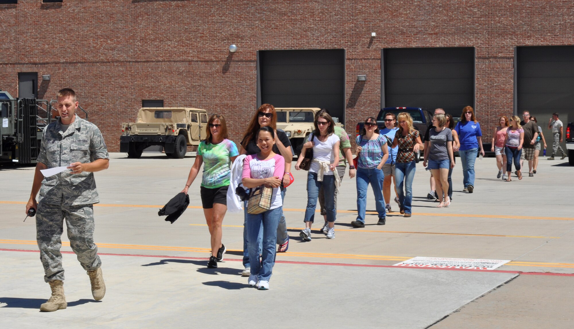 Spouses of 302nd Airlift Wing Airmen walk to board two awaiting C-130 Hercules aircraft Aug. 7 during the Wing Spouse's Orientation Flight at Peterson Air Force Base, Colo. More than 60 spouses took participated in the orientation training mission to see and learn more about the Air Force Reserve organization their significant others are assigned to. (U.S. Air Force photo/Staff Sgt. Stephen J. Collier) 