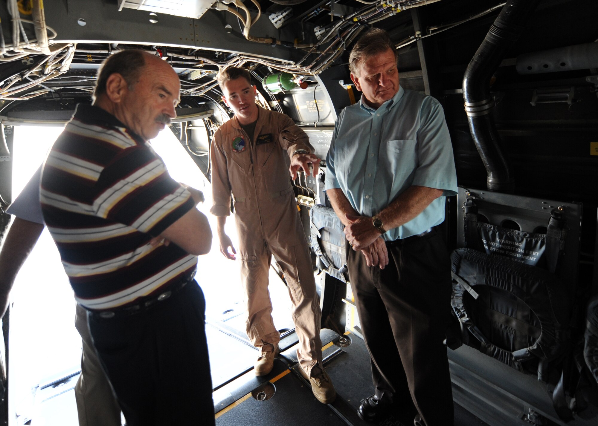 U.S. Marine Corps Capt. Andrew Brayton, a pilot assigned to Marine Medium Tiltrotor Squadron 166 out of Marine Corps Air Station Miramar, Calif., gives Mayor Tom Rist and Billy Richie, special assistant to the governor for military affairs, a tour of the inside of a VM-22 Osprey aircraft at Mountain Home Air Force Base, Idaho, Aug. 17, 2011. The MV-22 Osprey combines the vertical flight capabilities of a helicopter with the speed and range of an airplane and is designed for expeditionary assault, raid operations, cargo lift and special warfare. (U.S. Air Force photo by Senior Airman Debbie Lockhart)