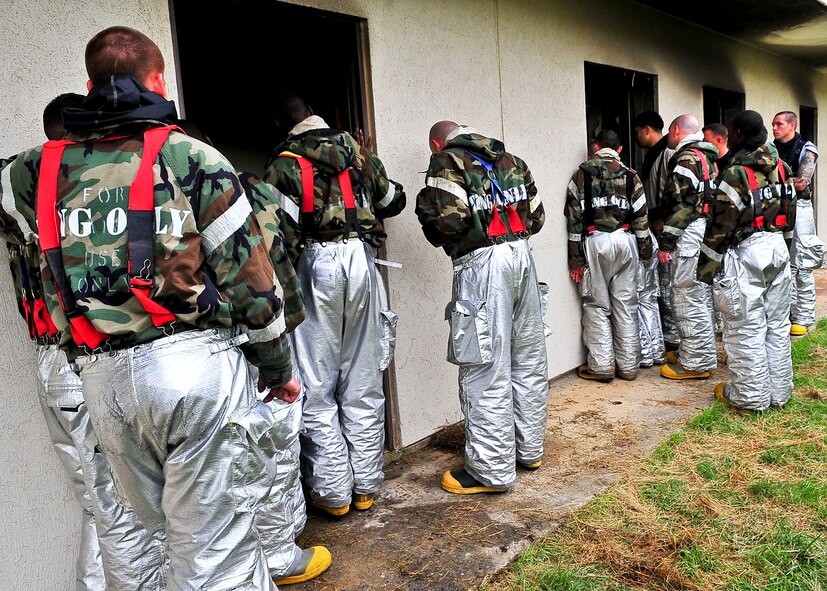Members of the 51st Fighter Wing Civil Engineer Squadron, await a training brief before participating in Silver Flag a two week long exercise held to sharpen contingency training, Aug. 16. During the training   members were trained on JS-List Structural Fire Fighting which is a requirement of all bases with in the Pacific Forces. (U.S. Air Force Photo by/ Senior Airman Adam Grant)