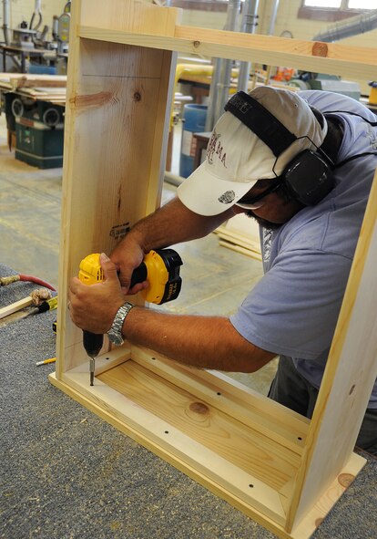 Retired Senior Master Sgt. Mahmoud Rasouliyan tightens a screw with a power drill at the woodshop on Barksdale Air Force Base, La., Aug. 17. The woodshop is located in the Arts and Crafts Center, and personnel can be qualified to use the equipment during business hours. (U.S. Air Force Photo/2nd Lt. Tori Lalich)(RELEASED)