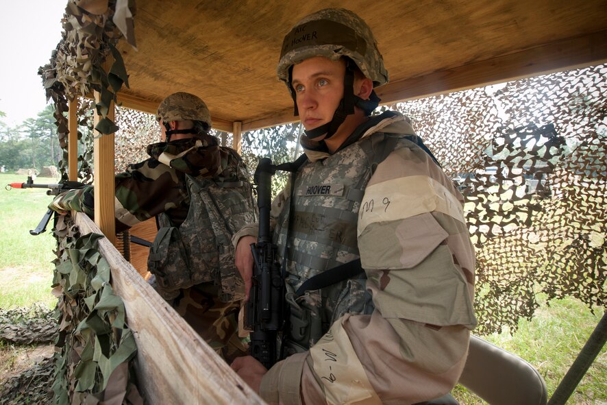 U.S. Air Force Airman 1st Class Blake Peavy, 23rd Security Forces Squadron (SFS), and Airman 1st Class Cody Hoover, 23rd Civil Engineer Squadron (CES) augmentee, watch the perimeter of Base X during a phase II operational readiness exercise at Moody Air Force Base, Ga., Aug. 16, 2011. The 23rd SFS and 23rd CES augmentees worked together to ensure the location was secure. (U.S. Air Force Photo by Staff Sgt. Joshua J. Garcia/Released)