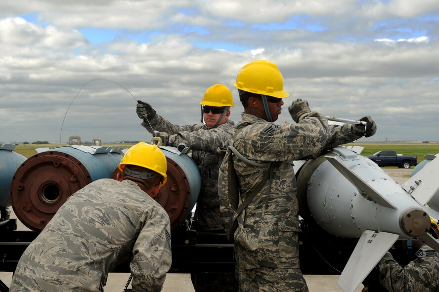 MINOT AIR FORCE BASE, N.D. -- 5th Munitions Squadron maintenance crew members help to assemble unguided conventional bombs during a practice run for the second annual Air Force Global Strike Command Global Strike Challenge here, Aug. 16. Minot Airmen from both the 5th Bomb Wing and the 91st Missile Wing participate in this year's AFGSC Global Strike Challenge during the months of June through November to showcase the world's premier bomber and ICBM force and to recognize outstanding AFGSC personnel and teams. (U.S Air Force photo by Senior Airman Aaron-Forrest Wainwright) (RELEASED)