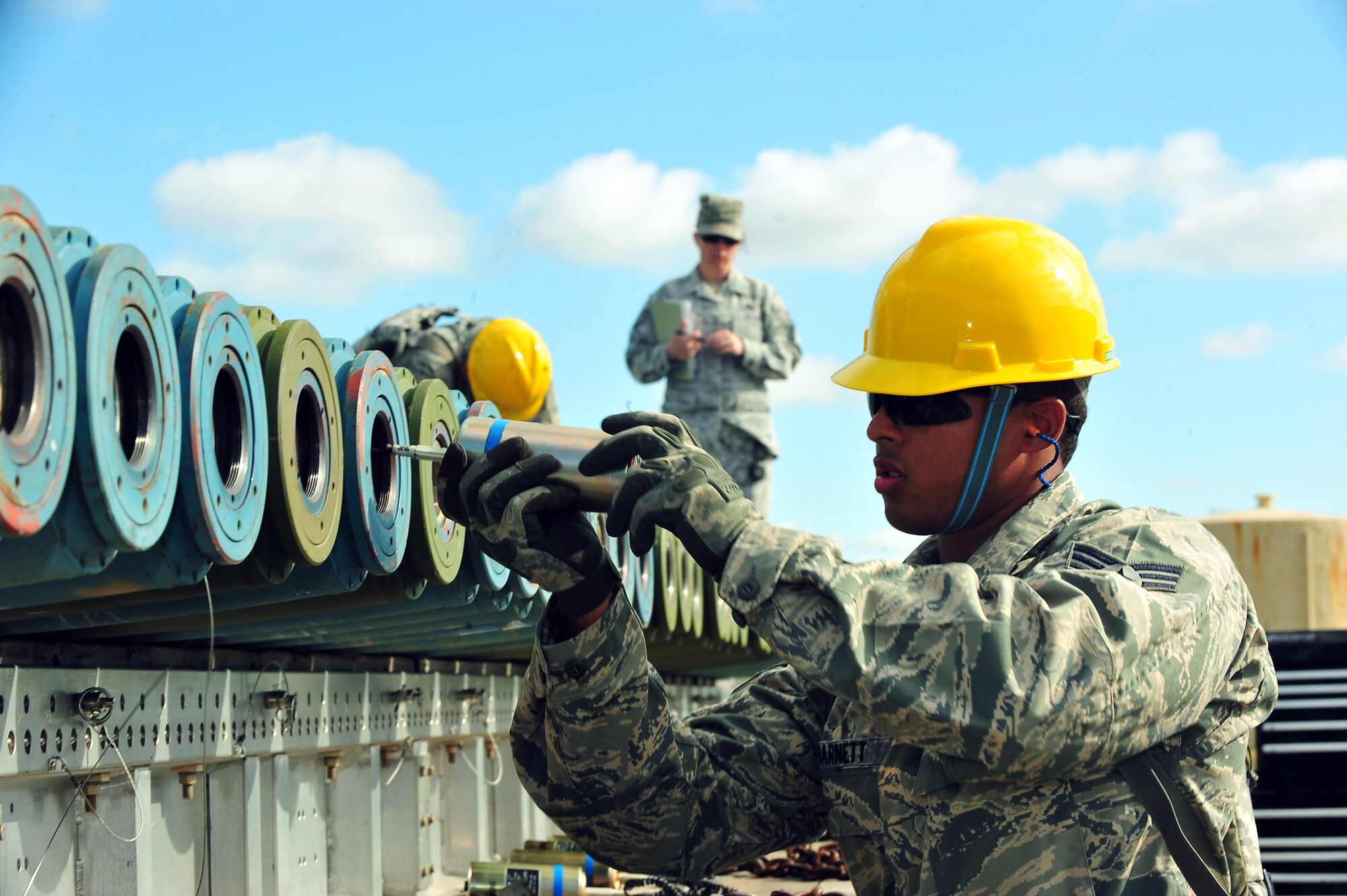 MINOT AIR FORCE BASE, N.D. – Senior Airman Dennis Barnett, 5th Munitions Squadron maintenance crew member, helps assemble unguided conventional bombs during  the second annual Air Force Global Strike Command Global Strike Challenge here, Aug. 16. Minot Airmen from both the 5th Bomb Wing and the 91st Missile Wing are participate in this year's AFGSC Global Strike Challenge during the months of June through November to showcase the world's premier bomber and ICBM force and to recognize outstanding AFGSC personnel and teams. (U.S Air Force photo by Senior Airman Jesse Lopez) (RELEASED)
