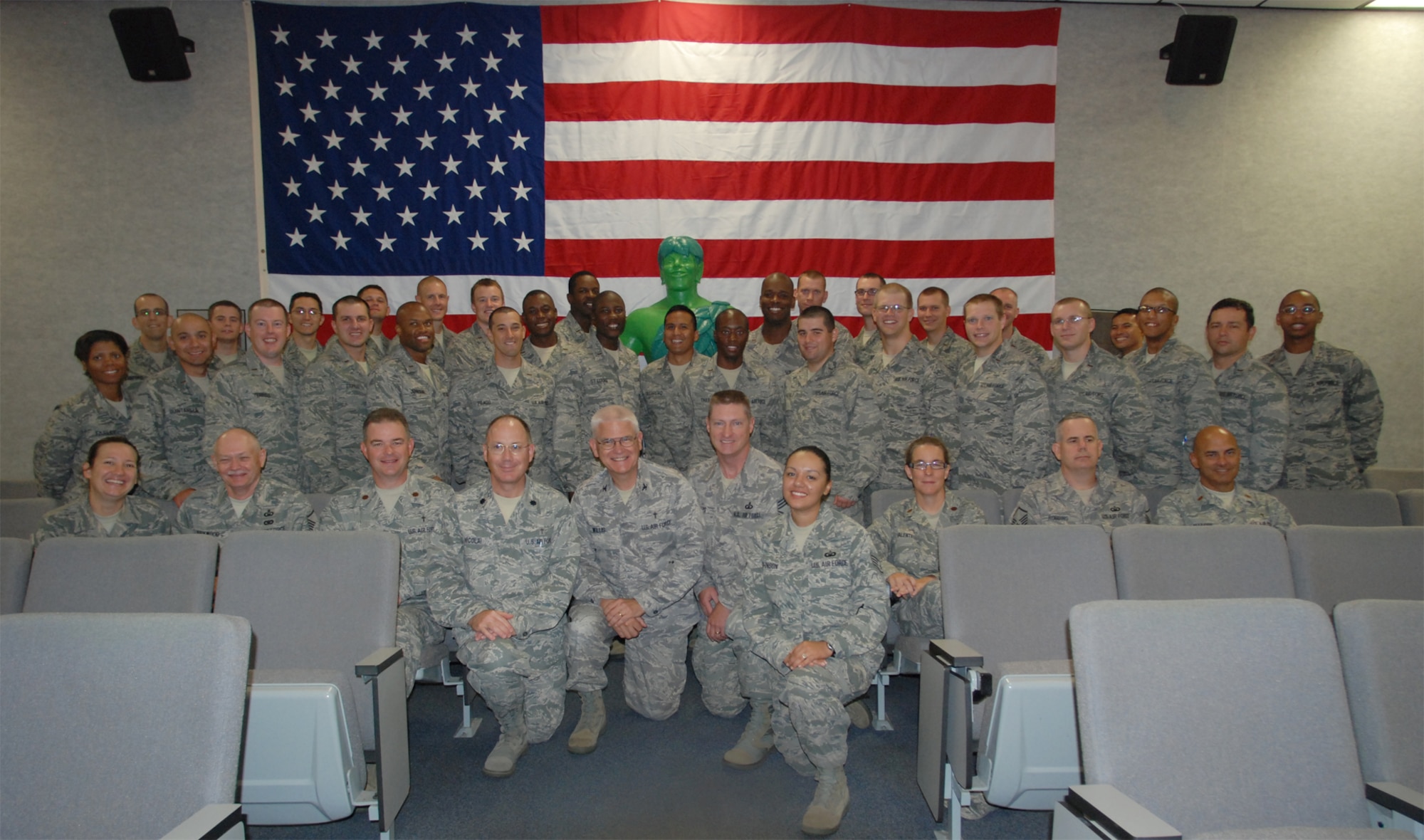 PATRICK AIR FORCE BASE, Fla.- Chaplain candidates, chaplains and chaplain mentors pose with the Jolly Green Giant in front of an American Flag. The group talked to the wings chaplain, Maj. Matthew C. Simpson while on tour at the 920th Rescue Wing here . The units missions are providing search and rescue support for civilians at sea who are lost or in distress, and providing humanitarian and disaster-relief operations. (U.S. Air Force photo/Airman 1st Class Natasha Dowridge)