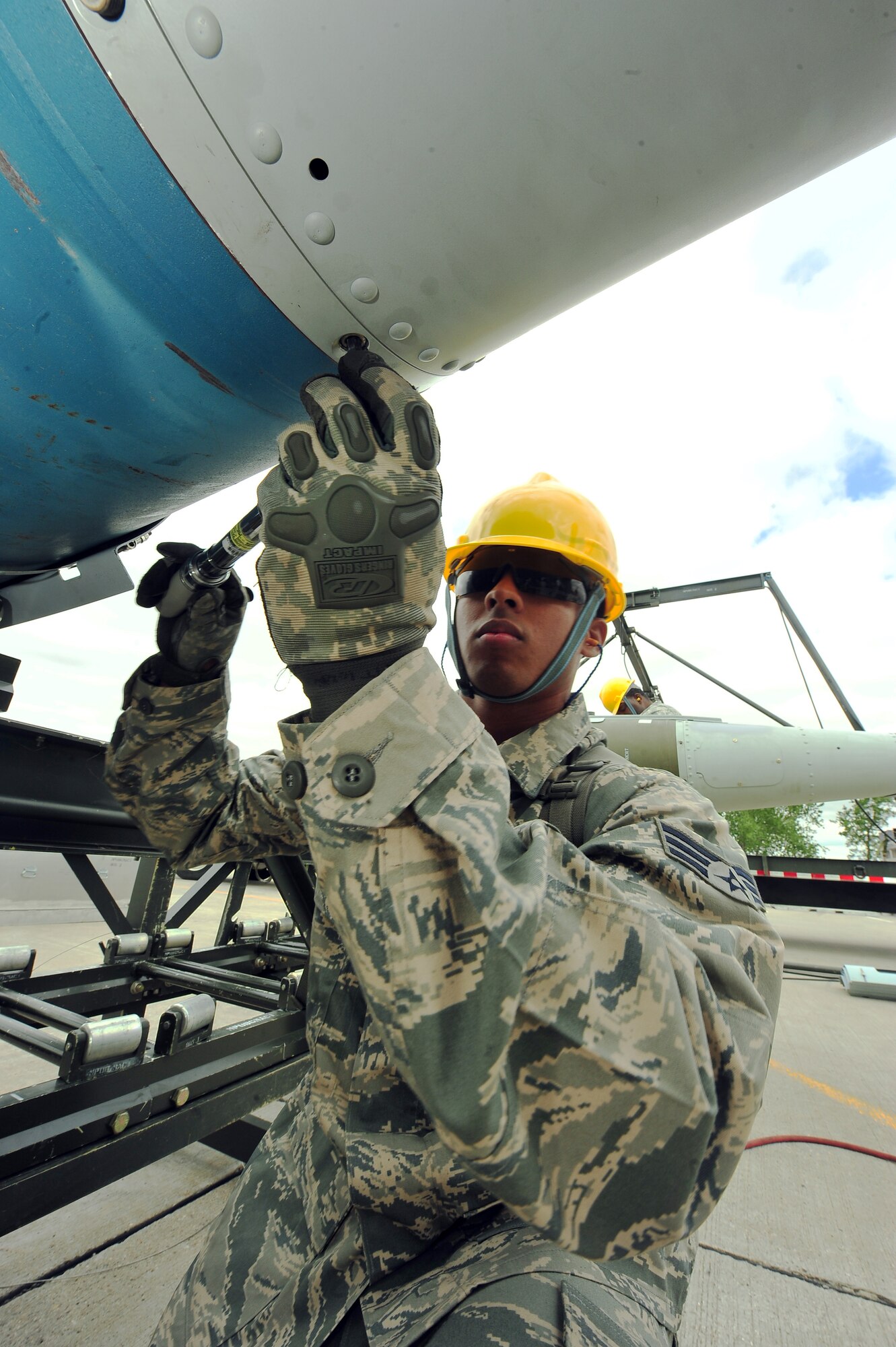 MINOT AIR FORCE BASE, N.D. – Senior Airman Dennis Barnett, 5th Munitions Squadron maintenance crew member, helps assemble unguided conventional bombs during the second annual Air Force Global Strike Command Global Strike Challenge here, Aug. 16. Minot Airmen from both the 5th Bomb Wing and the 91st Missile Wing participate in this year's AFGSC Global Strike Challenge during the months of June through November to showcase the world's premier bomber and ICBM force and to recognize outstanding AFGSC personnel and teams. (U.S Air Force photo by Senior Airman Jesse Lopez) (RELEASED)