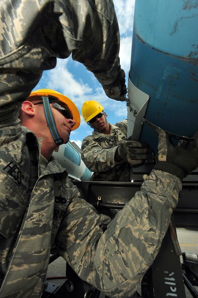 MINOT AIR FORCE BASE, N.D. – Senior Airman Dennis Barnett and Staff Sgt. Joseph Hess, 5th Munitions Squadron maintenance crew members, help assemble unguided conventional bombs during the second annual Air Force Global Strike Command Global Strike Challenge here, Aug. 16. Minot Airmen from both the 5th Bomb Wing and the 91st Missile Wing participate in this year's AFGSC Global Strike Challenge during the months of June through November to showcase the world's premier bomber and ICBM force and to recognize outstanding AFGSC personnel and teams. (U.S Air Force photo by Senior Airman Jesse Lopez) (RELEASED)