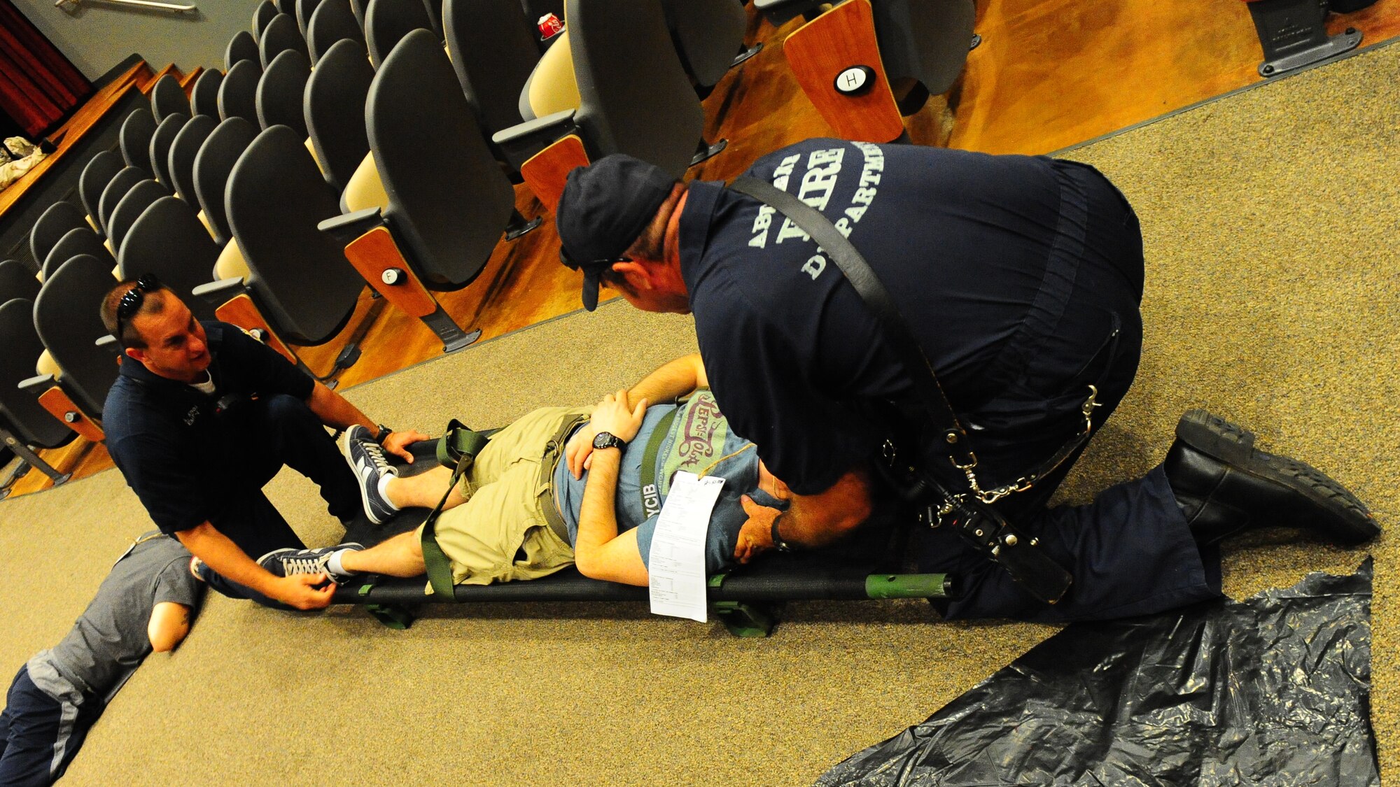 Abilene Fire Department firemen secure a victim to a litter during an Emergency Management Exercise Aug. 17, 2011 at Dyess Air Force Base, Texas. In this large-scale exercise, local Abilene emergency response agencies such as Abilene Homeland Security, Abilene Police Department, Abilene Fire Department and Hendricks Medical Center directly supported Dyess personnel in what was a hostage situation training exercise. (U.S. Air Force photo by Senior Airman Chelsea Browning/ Released)