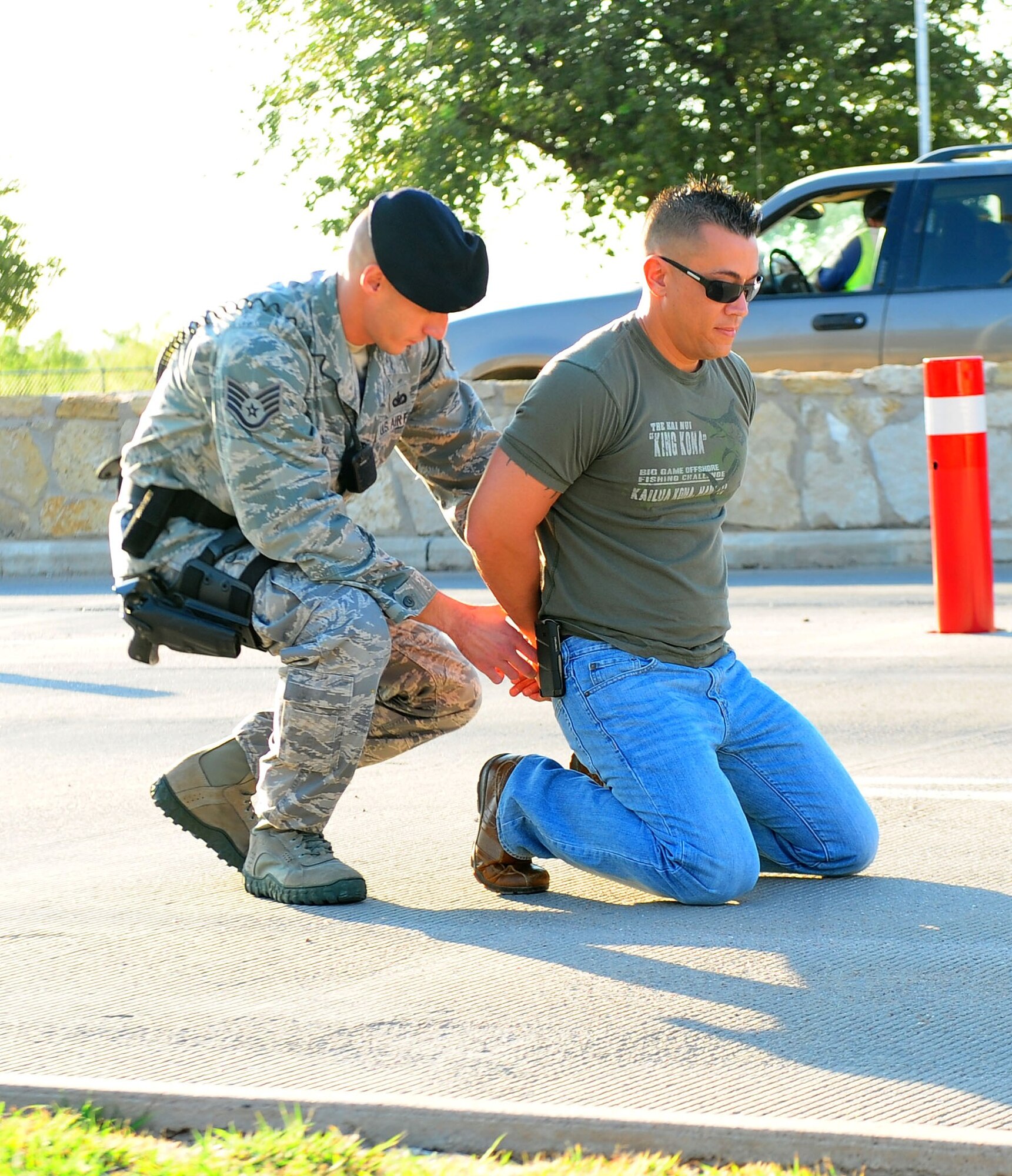 Staff Sgt. Shane Zugai, 7th Security Forces Squadron, detains a suspect during an Emergency Management Exercise Aug. 17, 2011 at Dyess Air Force Base, Texas.  Exercises such as these are critical to keep Dyess personnel prepared and ready for real-world situations and to successfully collaborate with Abilene emergency response teams. (U.S. Air Force photo by Senior Airman Chelsea Browning/ Released)