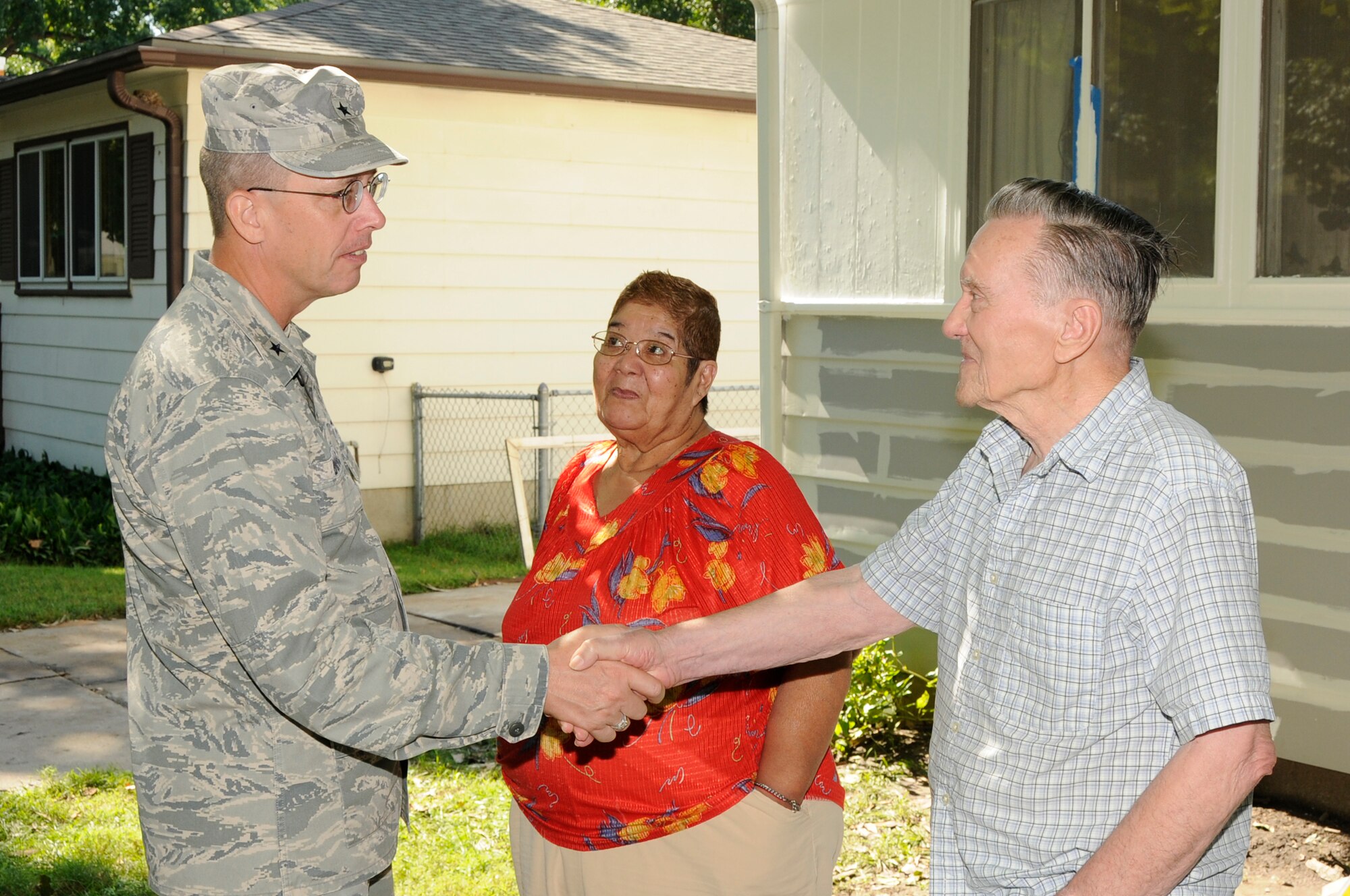 Brig. Gen. Daryl L. Bohac shakes the hands of Norman and Gloria Phillips, recipients of the Nebraska National Guard's annual Paint-a-thon in Lincoln, Neb. on Aug. 13, 2011. The Phillips' were nominated by applying for assistance through the Lincoln Action Program. (Nebraska Air National Guard photo by Master Sergeant Vern Moore) (Released)