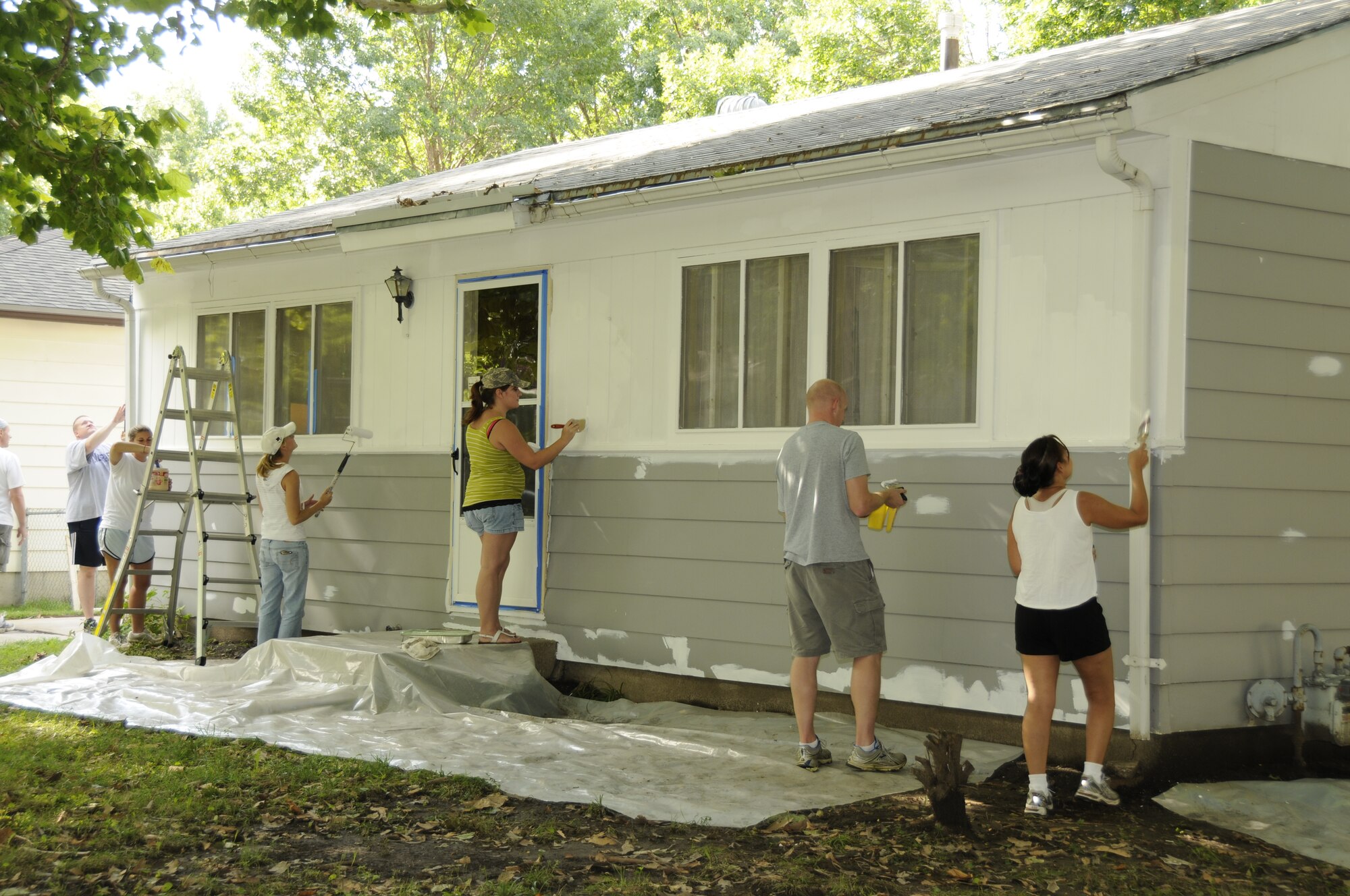 Members from the Nebraska Air and Army National Guard paint a house during the National Paint-a-thon in Lincoln, Neb. on Aug. 13, 2011. The Paint-a-thon is a program through the Lincoln Action Program to assist disabled, elderly, or financially unstable homeowners to preserve their home with a fresh coat of paint.  (Nebraska Air National Guard photo by Master Sergeant Vern Moore) (Released)