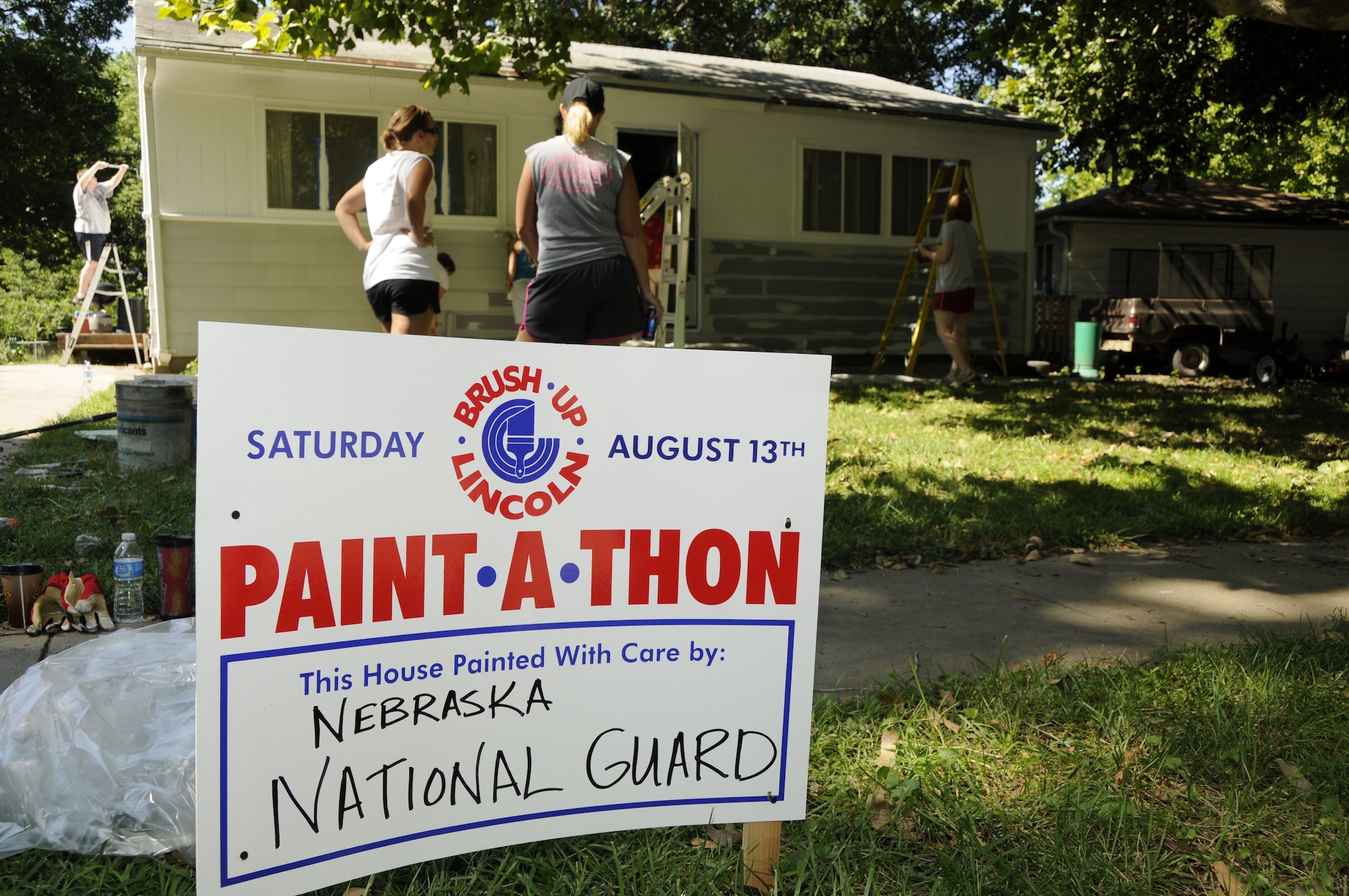 Members from the Nebraska Air and Army National Guard paint a house during the Lincoln Paint-a-thon hosted by Brush Up Nebraska in Lincoln, Neb. on Aug. 13, 2011. More than a dozen guardmembers, family, and friends came to the house to help paint.  (Nebraska Air National Guard photo by Master Sergeant Vern Moore) (Released)