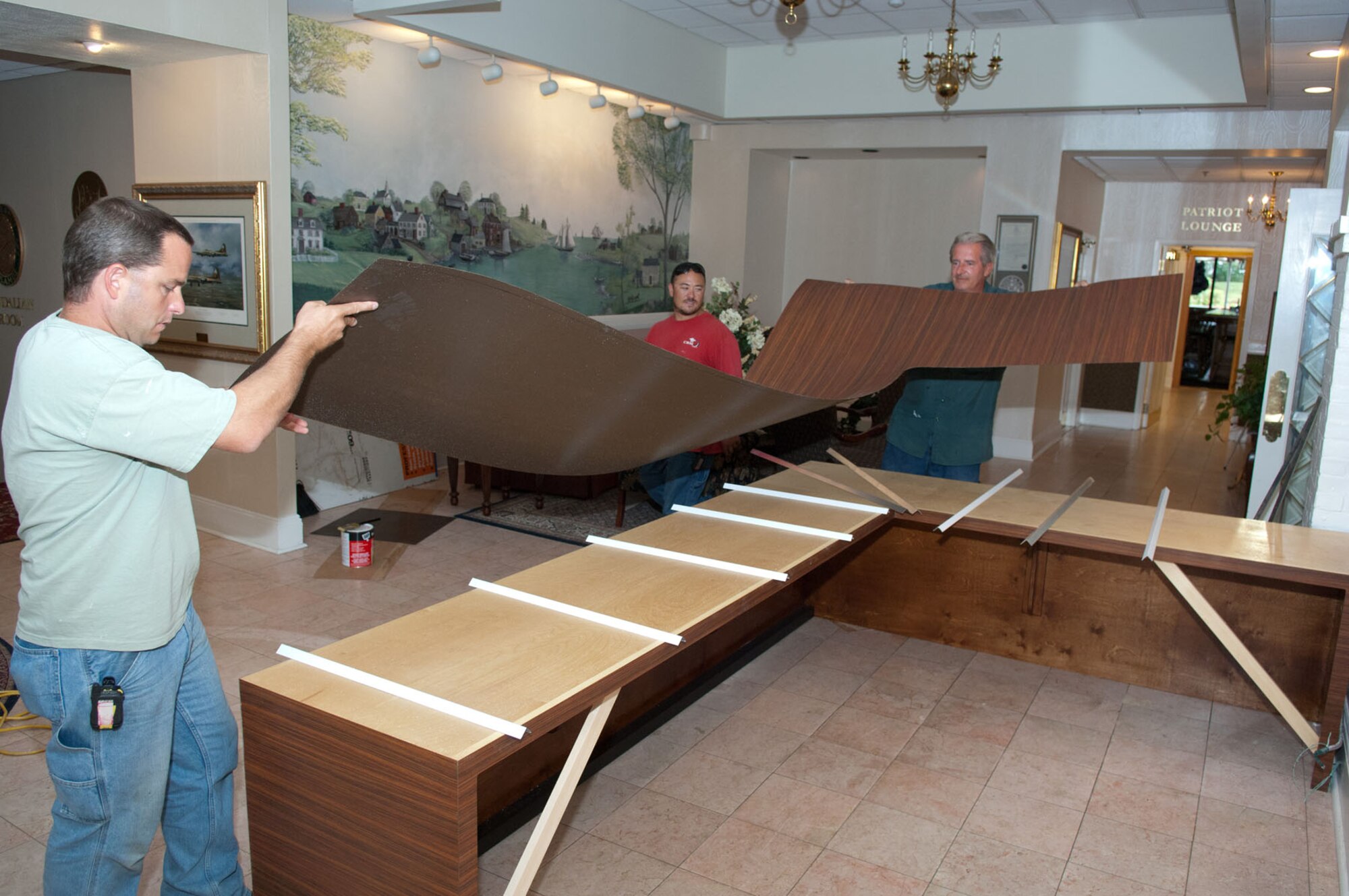 HANSCOM AIR FORCE BASE, Mass. – Crews work on installing a reception desk in the lobby area of the Minuteman Commons. 66th Force Support Squadron officials envision the former club becoming the hub of the base. (U.S. Air Force photo by Rick Berry)