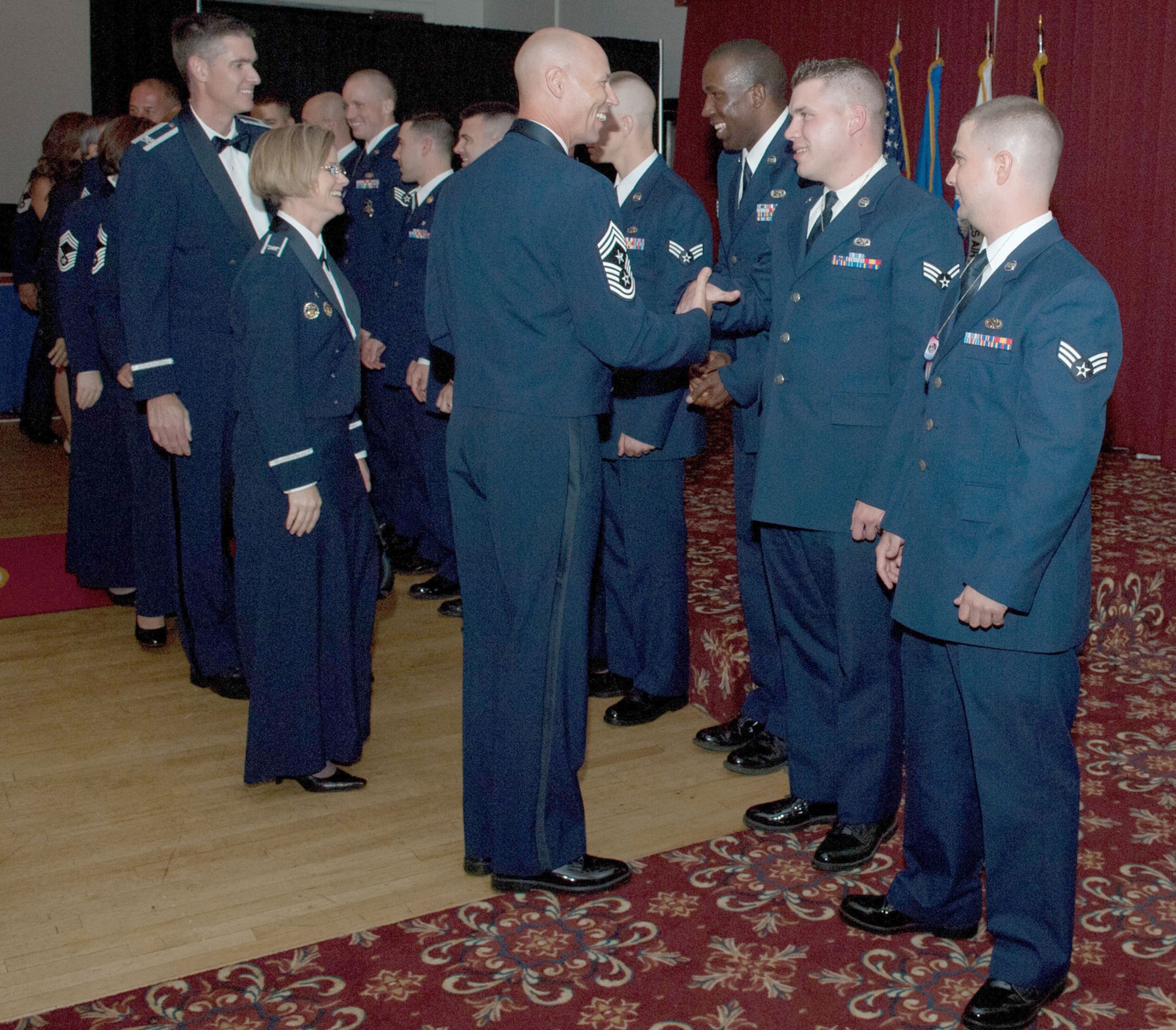 HANSCOM AIR FORCE BASE, Mass. – (front, right to left) Chief Master Sgt. Kevin Call, Electronic Systems Center command chief, Col. Stacy L. Yike, 66th Air Base Group commander, and Col. Mark Spillman, ESC vice commander, congratulate Airman Leadership School Class 11E graduates at the Minuteman Commons Aug. 12. (U.S. Air Force photo by Rick Berry)