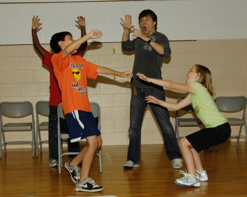 HANSCOM AIR FORCE BASE, Mass. - Eli Perez, Lauren Decker and Nicholas Reid (in back) take cues from Gage SteenVanger (middle) during practice at the Hanscom Primary School Aug. 16 for the Missoula Children’s Theater production of Robin Hood. The children will perform the play at the school Aug. 20 at 10 a.m. and 2 p.m. Admission will be free. (U.S. Air Force photo by Linda LaBonte Britt)