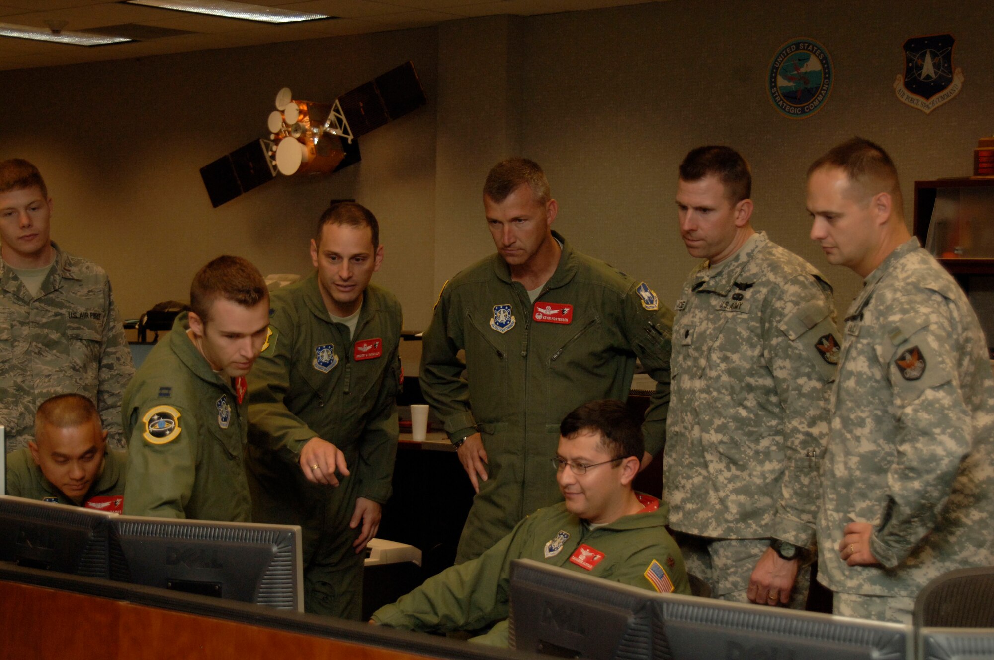 SCHRIEVER AIR FORCE BASE, Colo. -- Lt. Col. Kevin Mortensen, 3rd Space Operations Squadron commander, (center) and Lt. Col. Benjamin Jones, 53rd Signal Battalion commander (second from right), lead 3 SOPS members in deactivating the Defense Satellite Communications System B9 satellite here Aug. 12. (U.S. Air Force photo\Scott Prater).