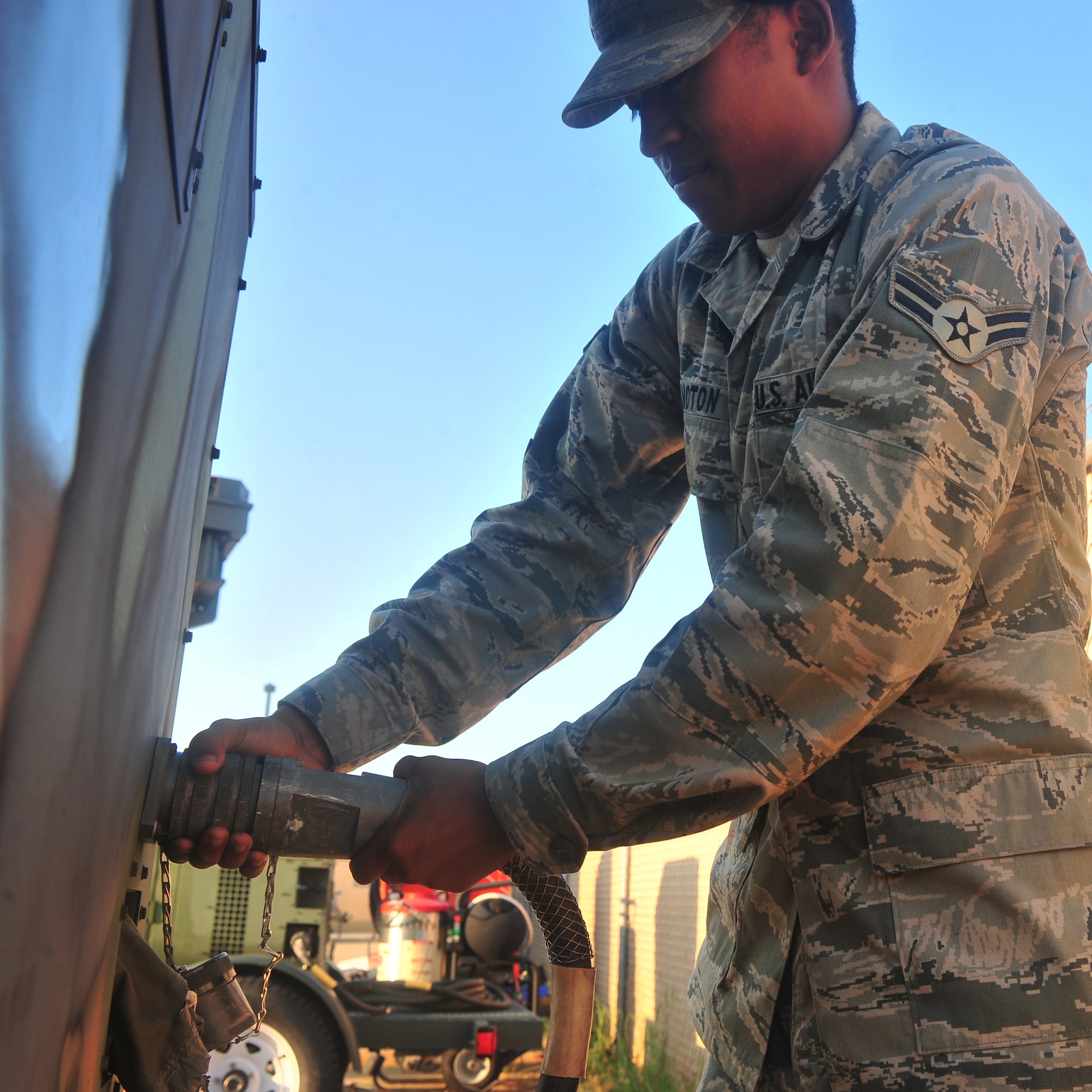 U.S. Air Force Airman 1st Class Julyon Moton, 20th Civil Engineer Squadron
electrical power production, makes sure everything on a generator is
connected properly at Shaw Air Force Base, S.C. Aug. 17, 2011. The electrical power production's job is making sure the base generators are up and running. (U.S. Air Force photo by Airman 1st Class Ashley Gardner/ Released)