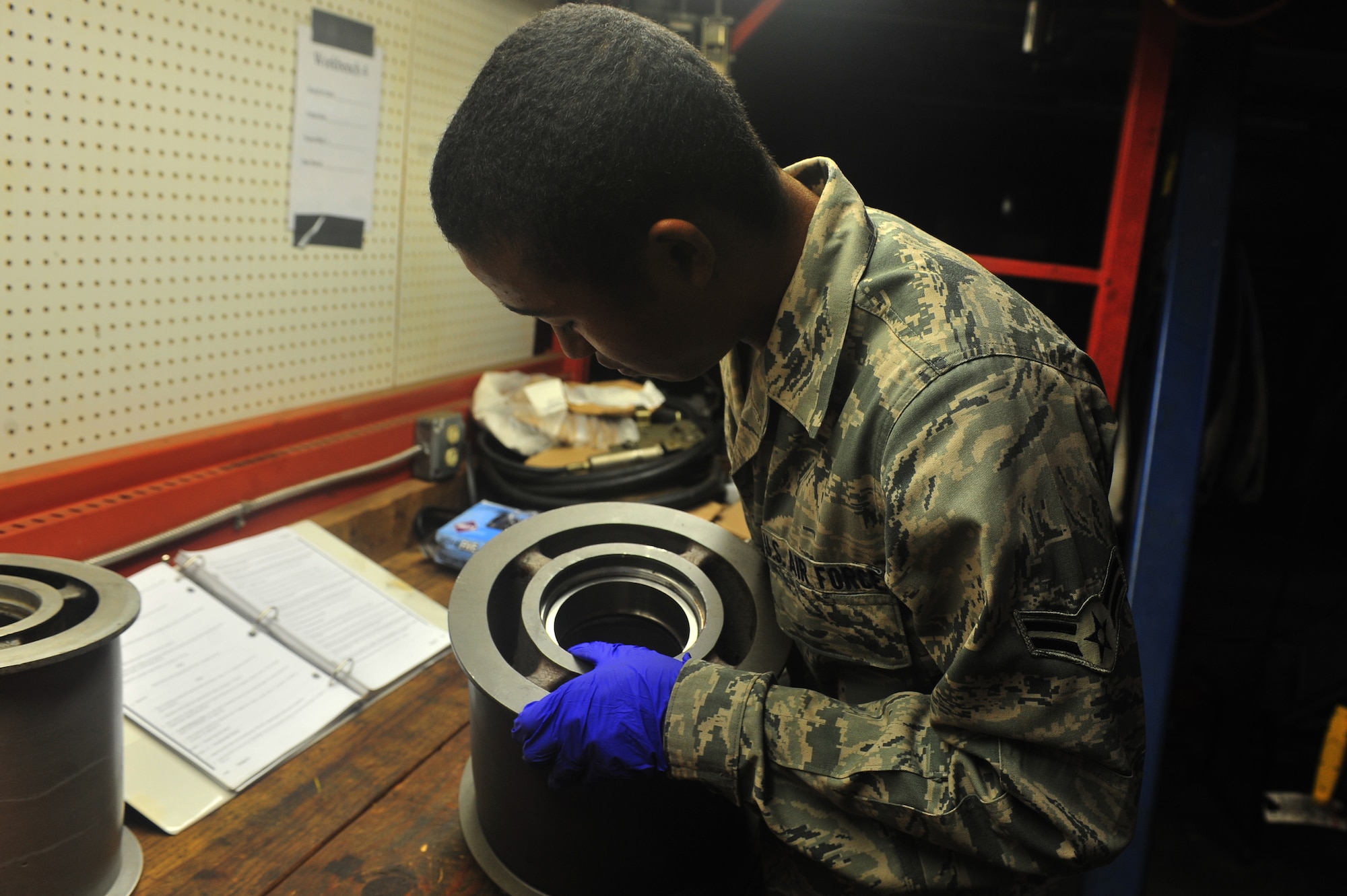 U.S. Air Force Airman 1st Class Julyon Moton, 20th Civil Engineer Squadron
electrical power production, assembles a roller to a burrier-arresting
kit-12 at Shaw Air Force Base, S.C Aug. 17, 2011. The electrical power production's job is making sure the base generators are up and running. (U.S. Air Force photo by Airman 1st Class Ashley Gardner/ Released)
