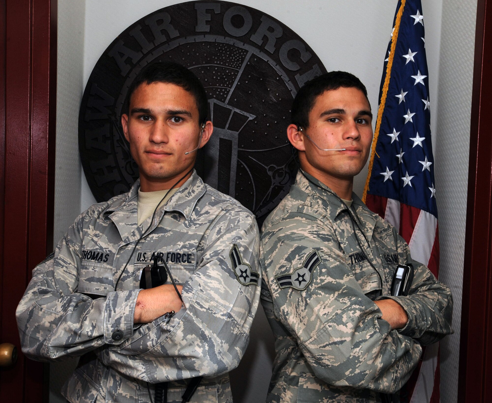 U.S. Air Force Airman 1st Class James Thomas, 20th Operation Support Squadron radar approach controller and Airman 1st Class Joseph Thomas, 20th OSS air traffic controller, pose for their picture, Shaw Air Force Base, S.C., Aug. 16, 2011. James and Joseph Thomas are identical twins, who have been stationed at Shaw AFB together for about 8 months.