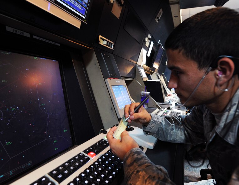 U.S. Air Force Airman 1st Class James Thomas, 20th Operation Support Squadron radar approach controller, looks at air activity on a map, Shaw AFB, S.C., Aug. 16, 2011. James and Joseph Thomas are identical twins, who have been stationed at Shaw AFB together for about 8 months.
