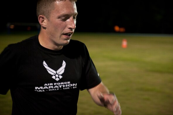 U.S. Air Force Staff Sgt. Thomas Heinig, 372nd Training Squadron C-130/HH-60 electronic and environmental instructor, finishes his final lap during a speed workout at Moody Air Force Base, Ga., Aug. 17, 2011. Heinig, who has been training Tuesdays, Thursdays and Saturdays since April for this year’s Air Force Marathon, said he has lost 50 pounds since beginning his training plan. (U.S. Air Force photo by Staff Sgt. Jamal D. Sutter/Released)