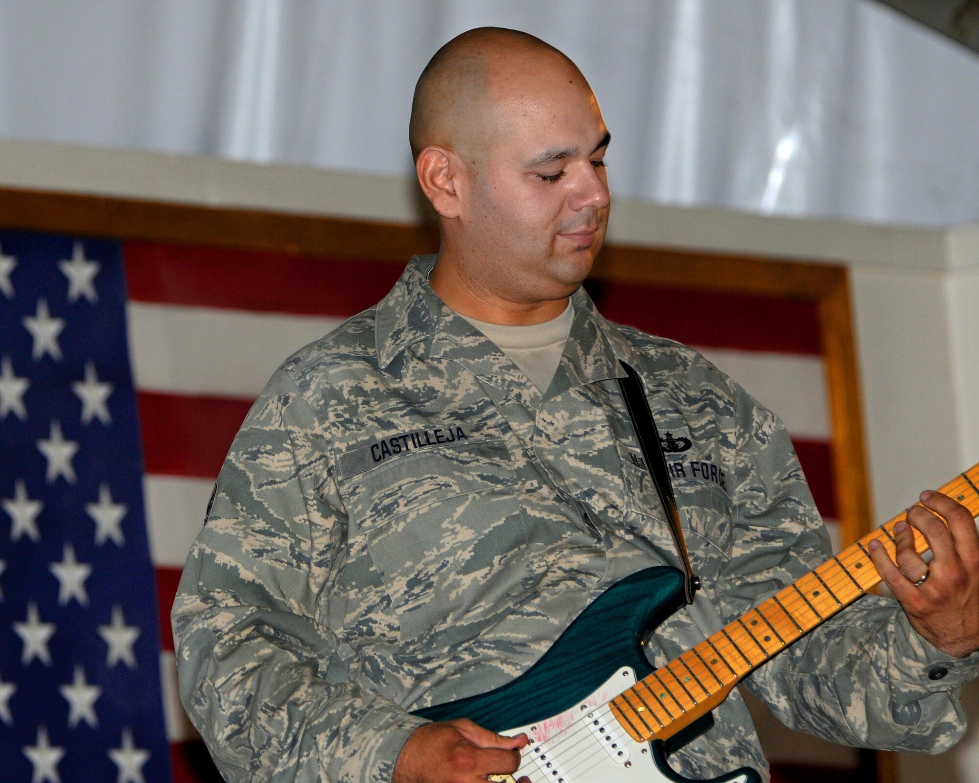 BAGRAM AIRFIELD, Afghanistan -- Tech. Sgt. Joseph Castilleja, U.S. Air Forces Central Expeditionary Band Sidewinder guitarist, performs at the Morale, Welfare and Recreation Clamshell here Aug. 13, 2011. The band played multiple shows each day to allow as many people as possible to attend the events. Its mission is to positively promote troop morale, diplomacy and outreach to host nation communities. (U.S. Air Force photo/Senior Airman Krista Rose) 