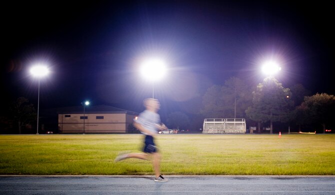 U.S. Air Force Staff Sgt. Aaron Williams, 372nd Training Squadron A-10 avionics instructor, sprints around the running track during a speed workout at Moody Air Force Base, Ga., Aug. 17, 2011. Williams and three of his teammates train for speed Tuesdays and Thursdays, and complete long runs Saturdays. (U.S. Air Force photo by Staff Sgt. Jamal D. Sutter/Released)