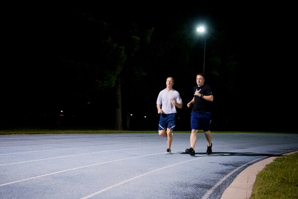 U.S. Air Force Staff Sgts. Aaron Williams and Thomas Heinig, 372nd Training Squadron instructors, complete a warm-up lap around the running track at Moody Air Force Base, Ga., Aug. 17, 2011. Williams and Heinig are currently training for the Air Force Marathon scheduled for Sept. 17, 2011, at Wright-Patterson Air Force Base, Ohio. It will be their second AF marathon in a row  (U.S. Air Force photo by Staff Sgt. Jamal D. Sutter/Released)