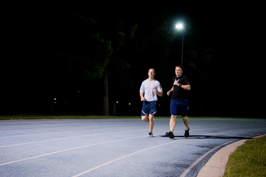 U.S. Air Force Staff Sgts. Aaron Williams and Thomas Heinig, 372nd Training Squadron instructors, complete a warm-up lap around the running track at Moody Air Force Base, Ga., Aug. 17, 2011. Williams and Heinig are currently training for the Air Force Marathon scheduled for Sept. 17, 2011, at Wright-Patterson Air Force Base, Ohio. It will be their second AF marathon in a row  (U.S. Air Force photo by Staff Sgt. Jamal D. Sutter/Released)