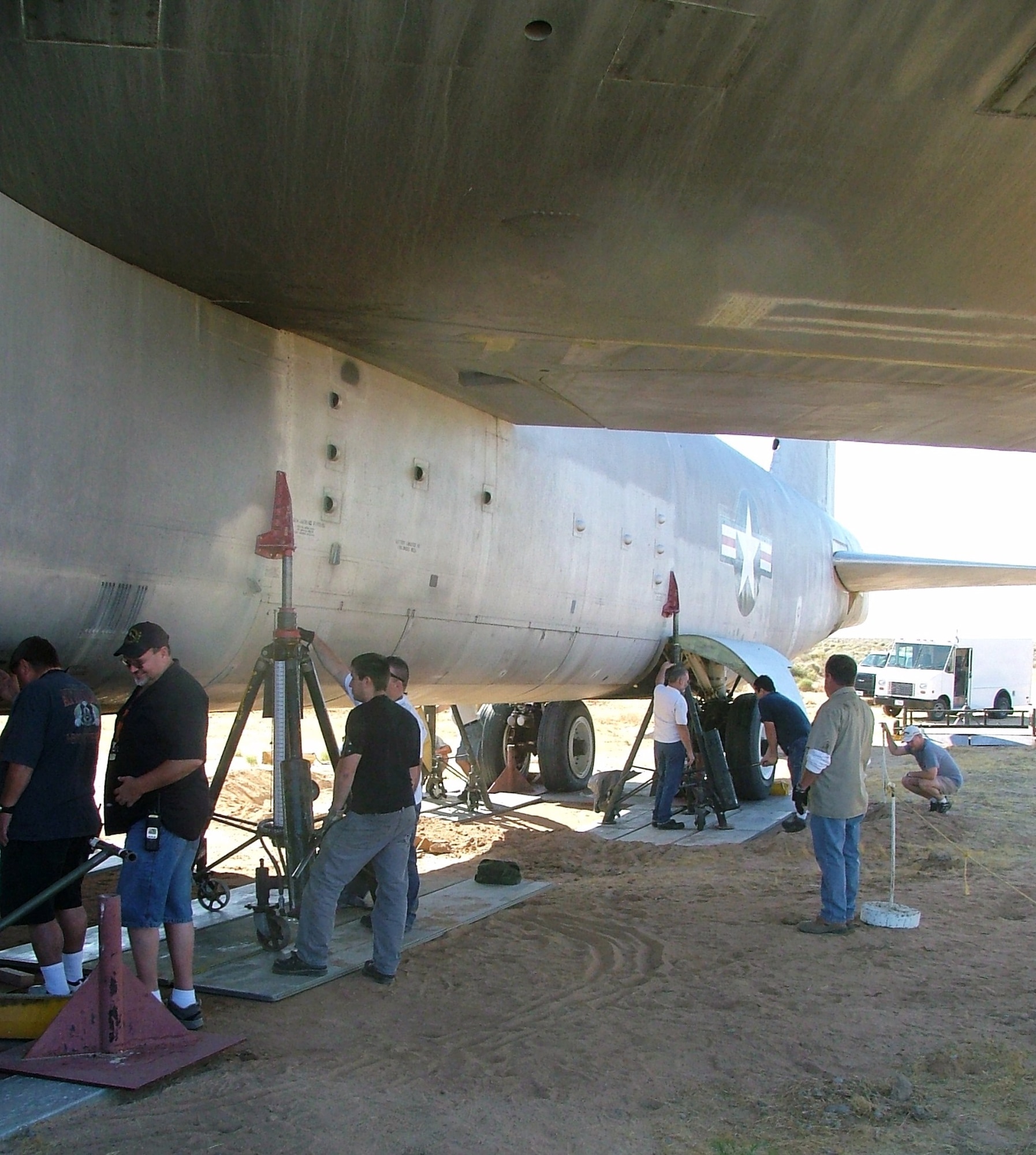 About 30 volunteers from the 412th Maintenance Group, 95th Civil Engineering and the Air Force Flight Test Center Museum, came out Aug. 6, to help lift the NB-52B displayed at Edwards’ North Gate off the ground and set it on specially made steel stands to take the load of its massive weight off the tires and landing gear. (Air Force photo by Tony Moore)