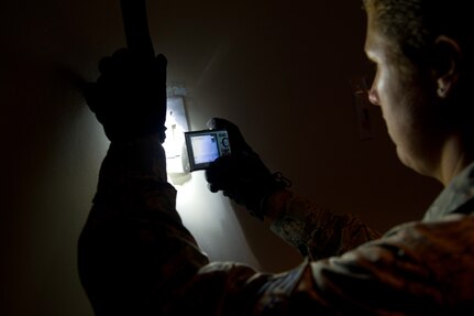 Tech. Sgt. Shelly Branch photographs texture and depth from a fingerprint during Battlefield Forensics training at Joint Base Charleston - Air Base Aug. 17. (U.S. Air Force photo/ Myles Cullen) 