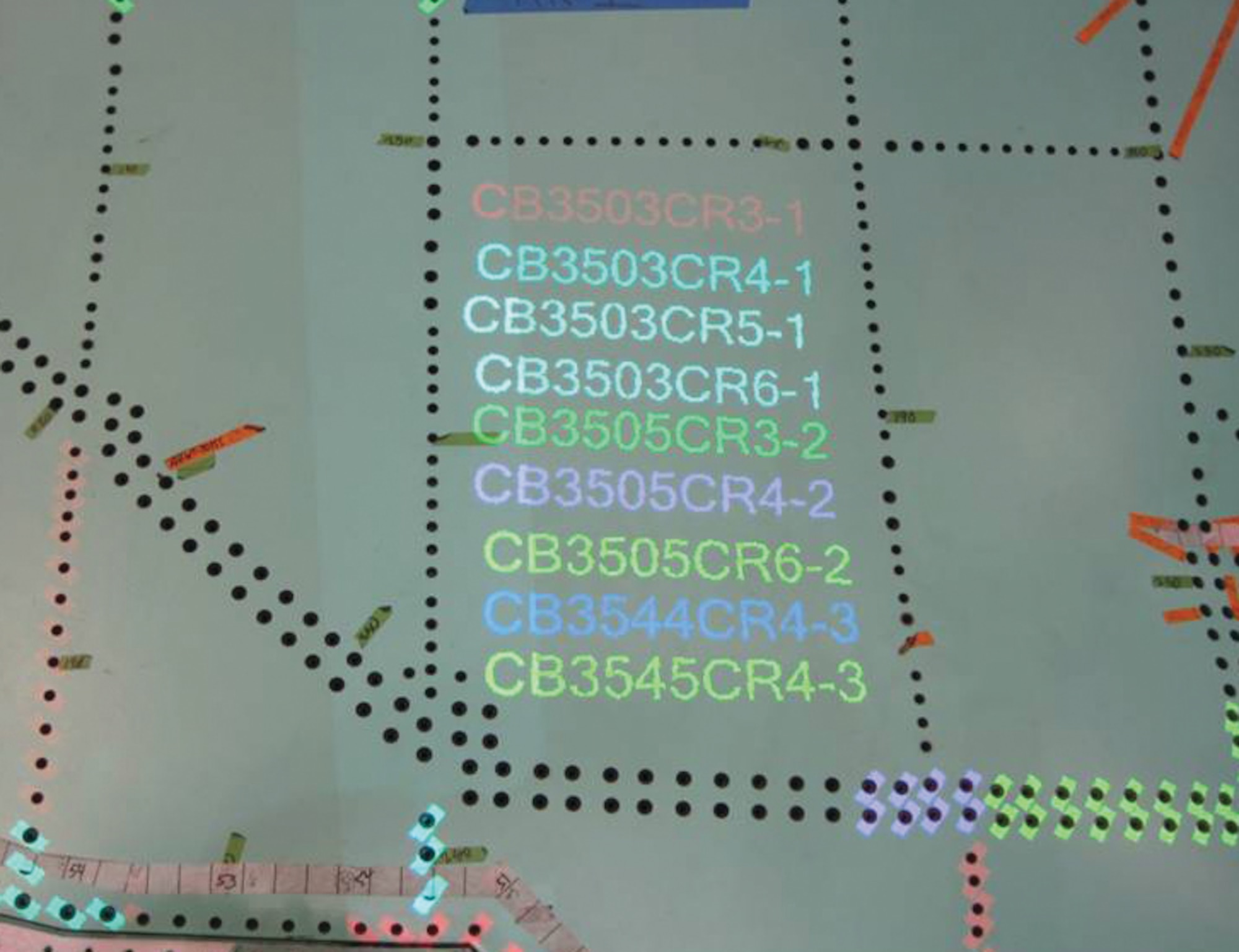 The FILLS projection system shows different fastener types. The system enhances hole location and fastener size information, reducing kitting preparation and delivery time, reduces fastener installation span time, and assures accuracy.  (AFRL Image)