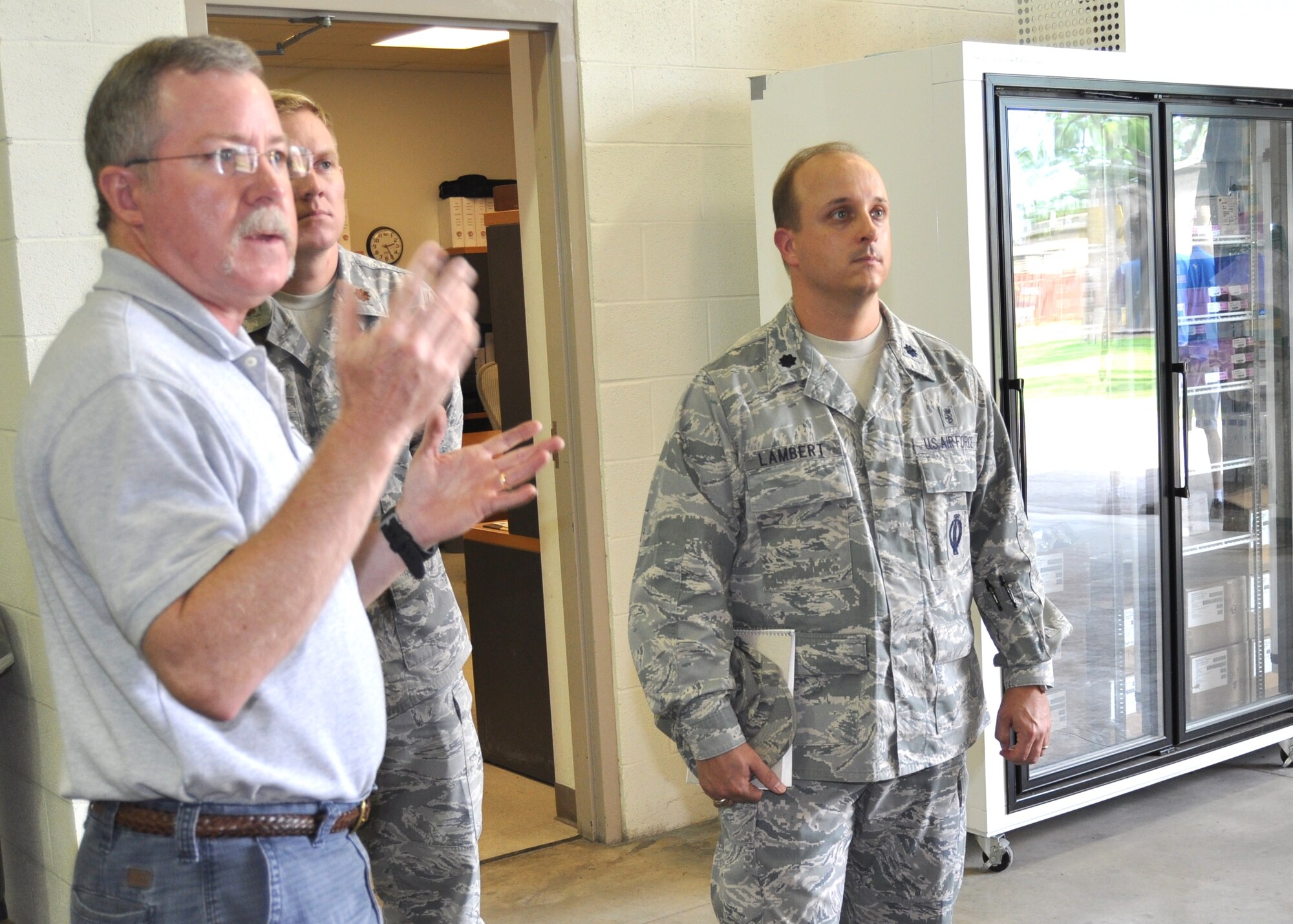 Norman Whitt, left, lead CACI war reserve materiel contractor, describes the work done
in the WRM warehouse to Lt. Col. Craig Lambert, right, new commander of the 81st Medical Support Squadron, Aug. 9 as Maj. Ronald Eller, the squadron’s logistics flight commander, listens. Lambert assumed command of the unit from Lt. Col. Michael Dietz July 6.  Lambert previously commanded the 45th MDSS, Patrick Air Force Base, Fla., and was the deputy commander and administrator of the 45th Medical Group. Dietz, who’s been selected for promotion to colonel, is now the hospital administrator at Langley AFB, Va.  (U.S. Air Force photo by Steve Pivnick)