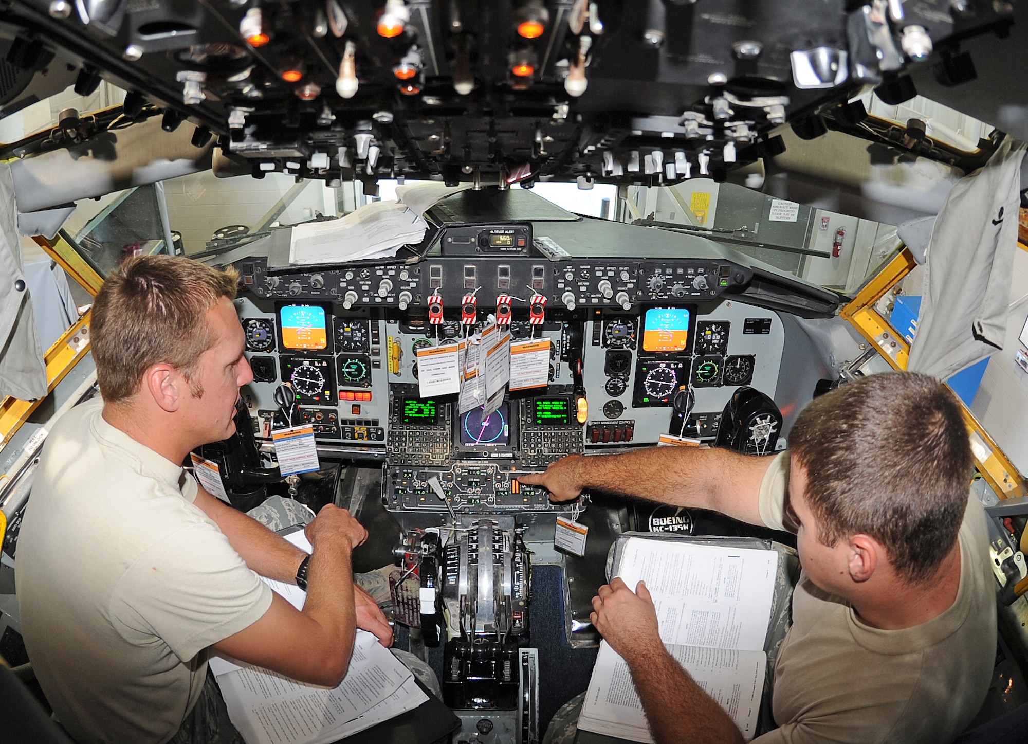 SEYMOUR JOHNSON AIR FORCE BASE, N.C. -- Staff Sgt. Dwyane Elders, 911th Air Refueling Squadron integrated avionics systems lead technician, trains Airman Wesley Miller, 916th Air Refueling Wing integrated avionics systems apprentice, on how to properly test multifunctional displays on a KC-135R Stratotanker here Aug. 16, 2011.  Elders hails from Deerborn, Mich., and Miller hails from Albertson. (U.S. Air Force photo by Senior Airman Gino Reyes/Released)