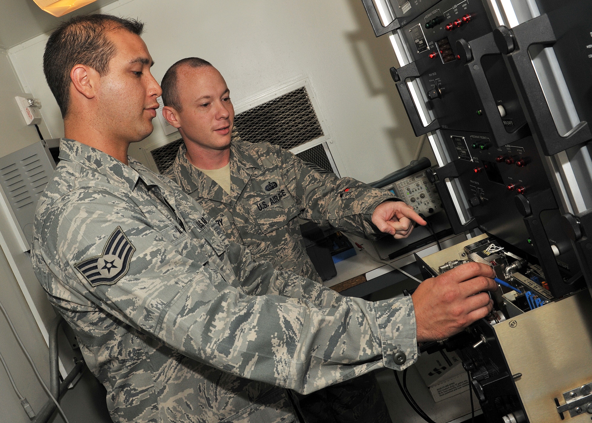 RAF MILDENHALL, England -- Staff Sgt. Lucas King (left), 100th Communications Squadron Airfield Systems technician, and Tech. Sgt. Jonathan Montgomery, 100th CS Airfield Systems shift lead, perform a preventive maintenance inspection on a localizer here Aug. 17, 2011.  The equipment is a vital part to aircraft landing safely during inclement weather.  (U.S. Air Force photo/Staff Sgt. Tabitha M. Lee)